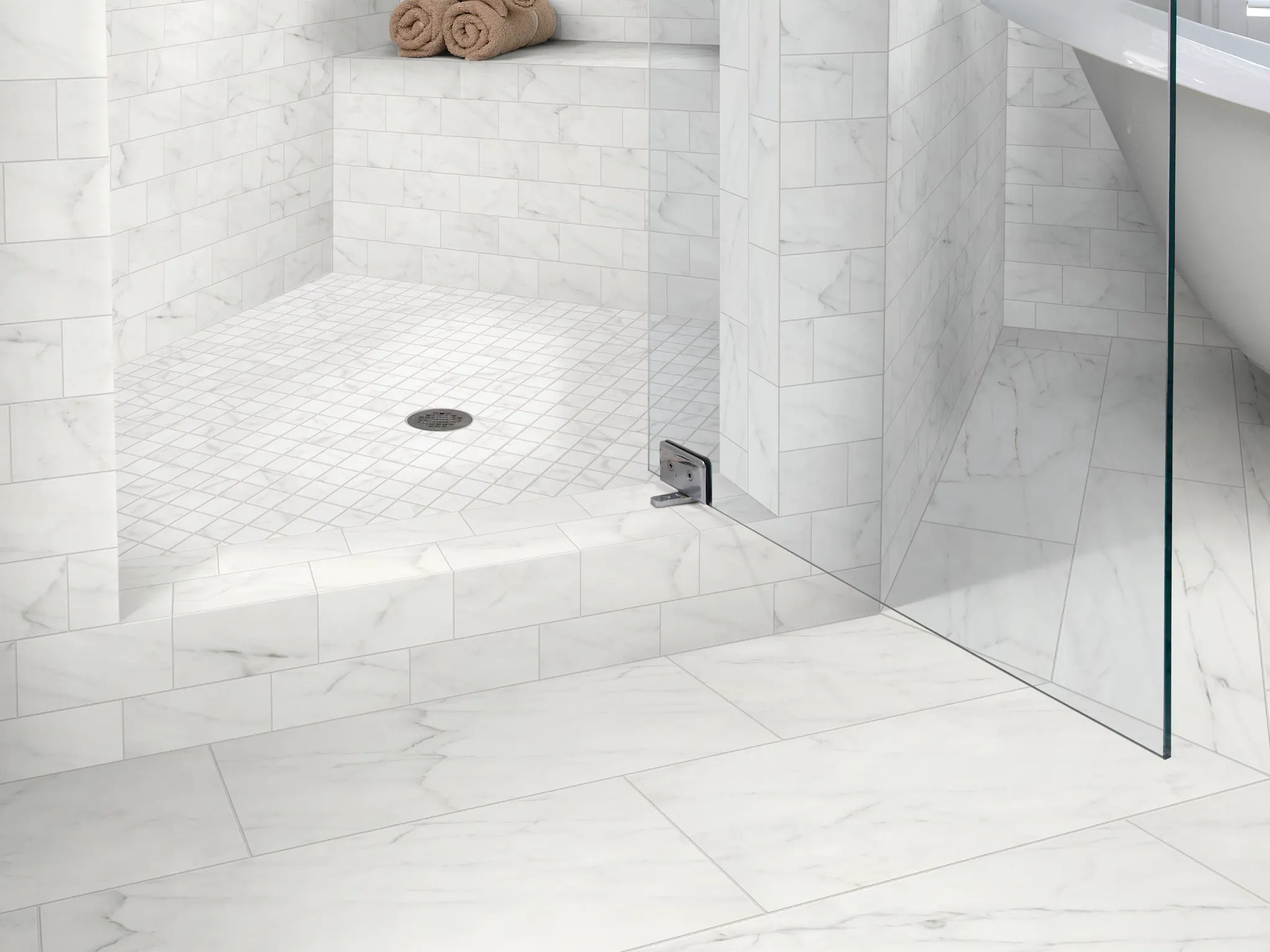 Elegant white marble tile shower with glass door and bench