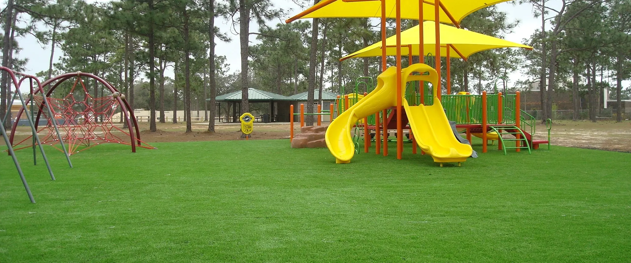Playground with artificial grass and colorful equipment