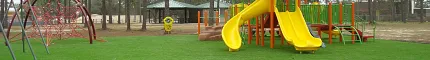 Playground with artificial grass and colorful equipment