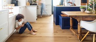 A family in a kitchen with COREtec luxury vinyl flooring visible