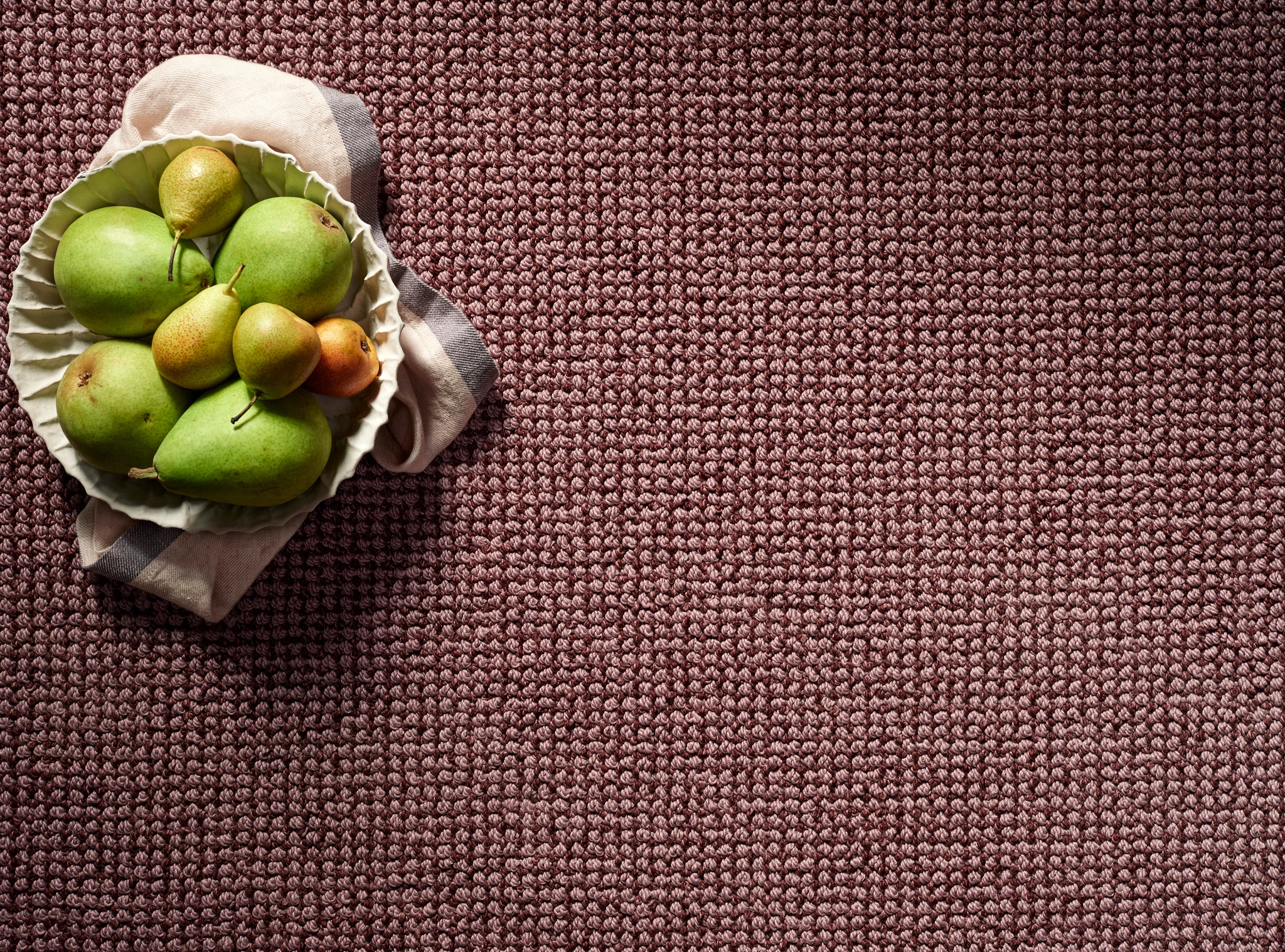 Close-up of a textured broadloom carpet in maroon