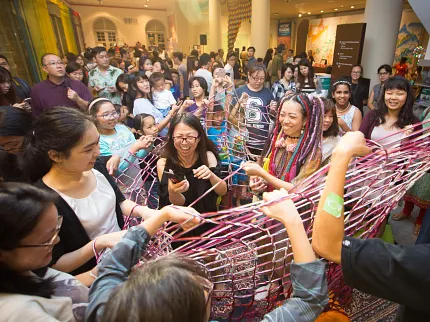 Interactive Art Installation in Public Space Group of people engaging in a colorful interactive art installation in a public space