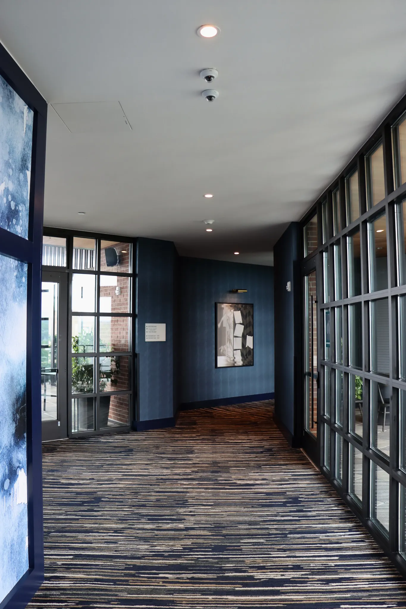 Modern hallway with commercial carpet tile in blue and beige tones