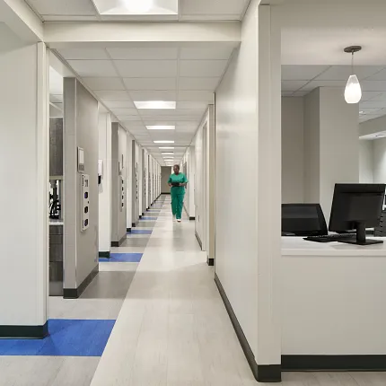 Durable flooring for healthcare environments Modern hospital corridor with light and blue flooring