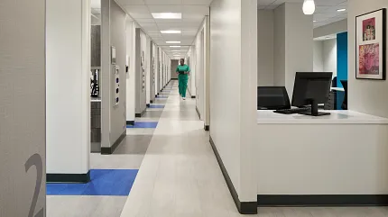 Durable flooring for healthcare environments Modern hospital corridor with light and blue flooring