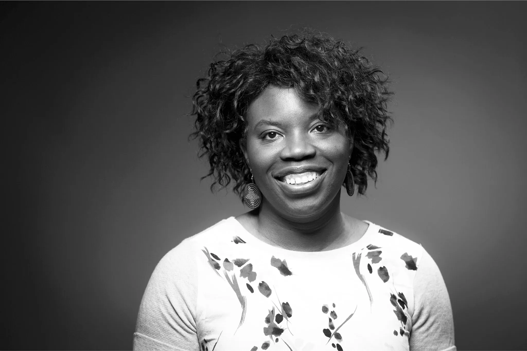 Black and white image of a person wearing a floral patterned shirt