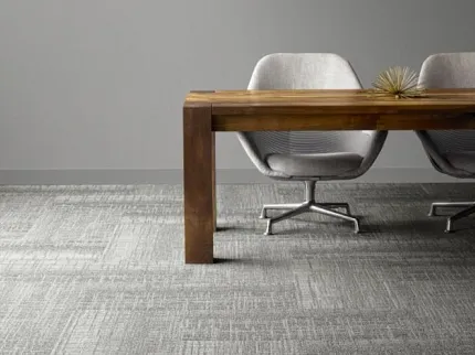 Gray Carpet Flooring in Modern Office Setting with Wooden Table and Chairs Modern office setting with gray carpet flooring, wooden table, and two gray chairs
