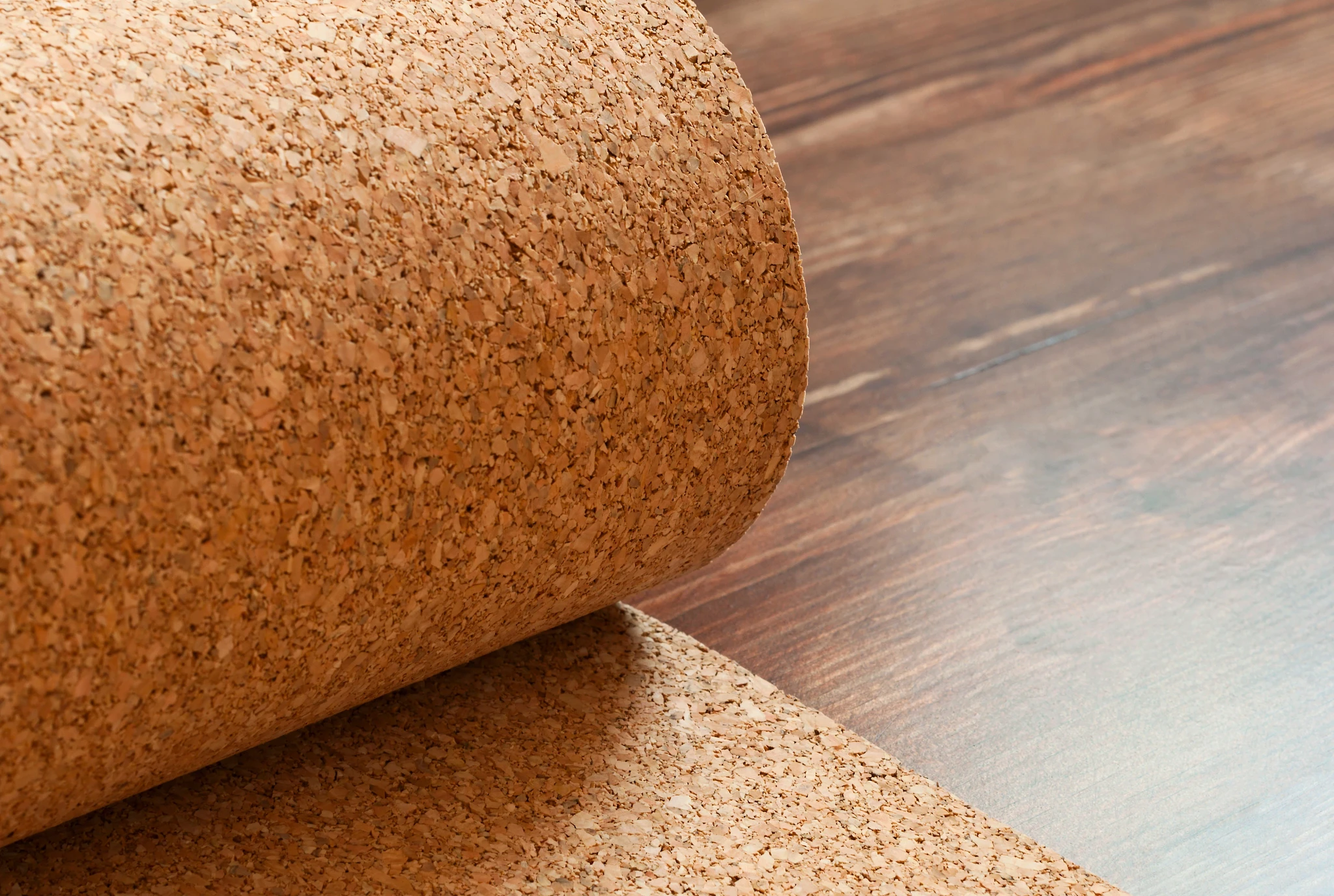 Cork underlayment roll on hardwood flooring for enhanced comfort and sound insulation