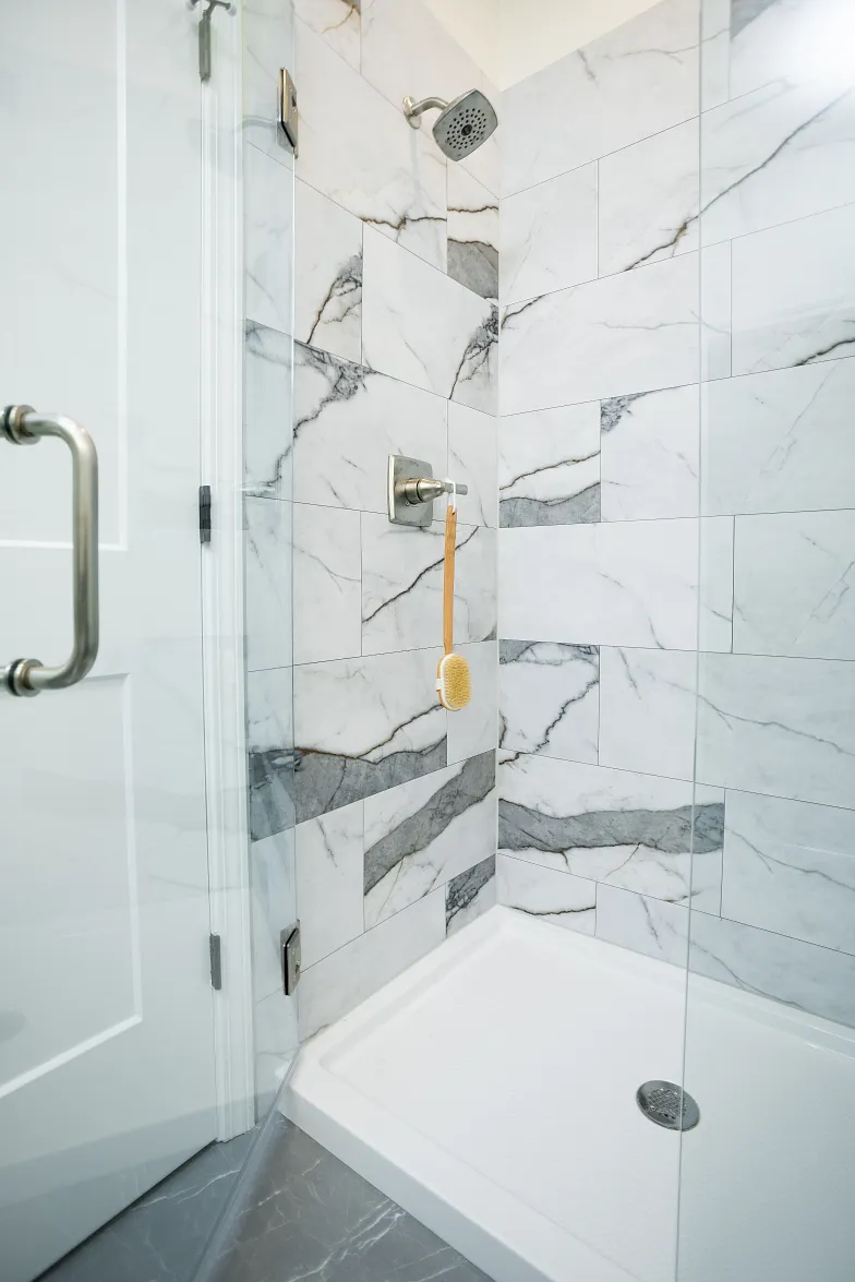 Shower Wall Elements in color Michelangelo Marble installed in a glass walled shower
