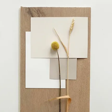 Light Oak Wood Look Vinyl Flooring Swatch with Neutral Color Palette Light oak wood look vinyl flooring swatch with beige, white, and taupe color samples and dried floral accents