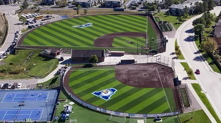 Expansive sports facility with multiple fields and courts Aerial view of sports complex with baseball fields and tennis courts