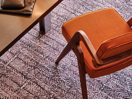 Office Interior with Commercial Carpet Tile and Orange Chair Modern office setting with a wooden table and orange chair on a patterned commercial carpet tile floor