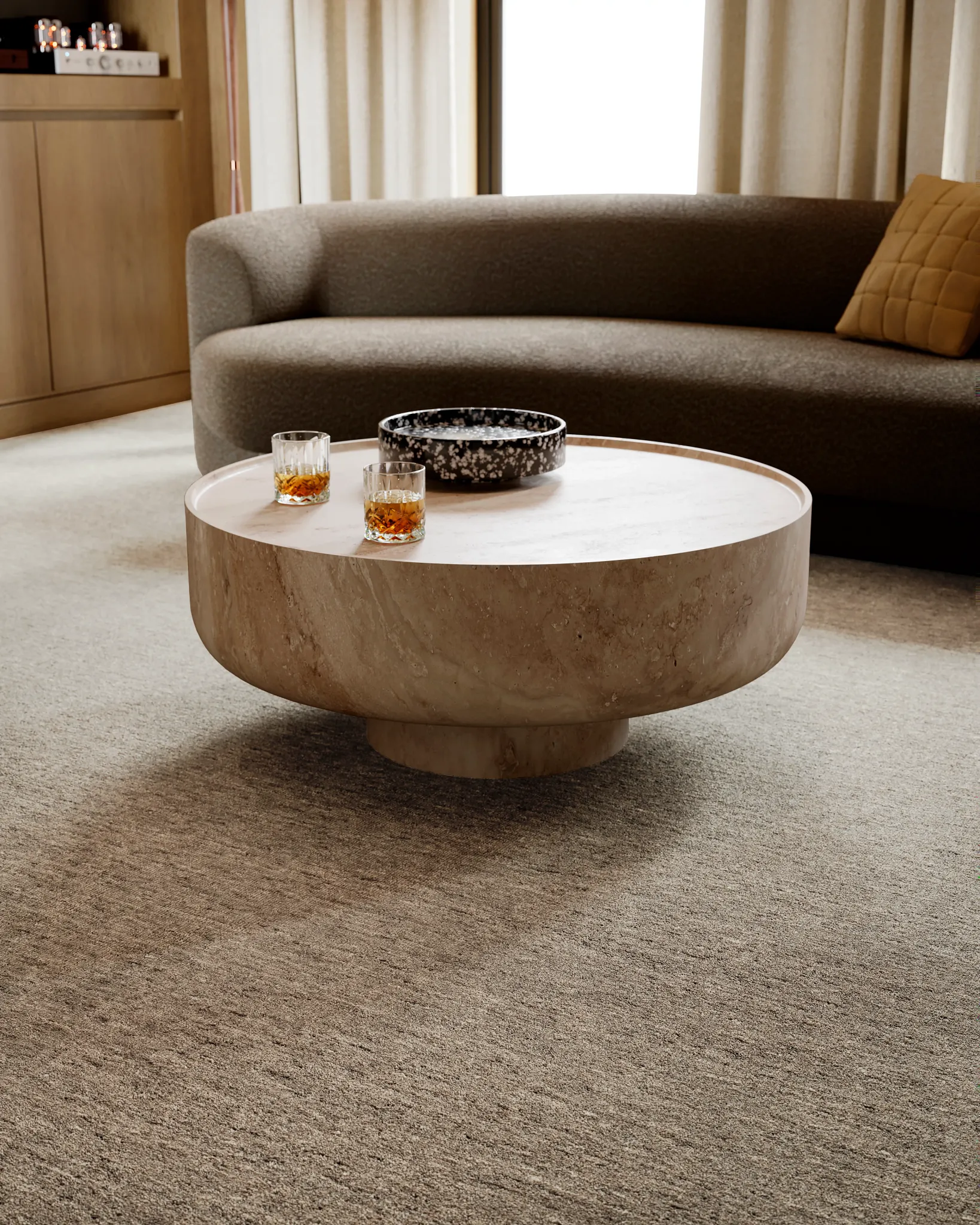 Modern living room with a round stone coffee table and 100% wool carpet in neutral tones
