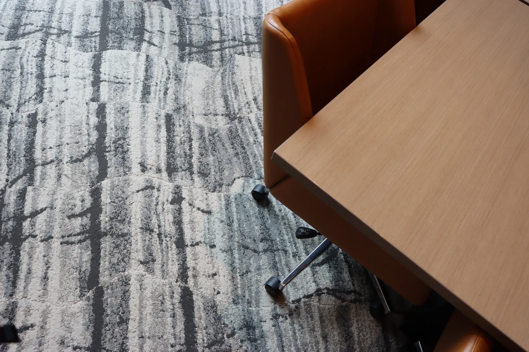 Modern office with abstract patterned carpet and leather chairs
