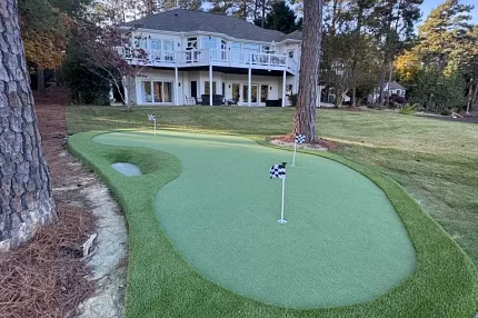 Enhance your home with a stylish backyard putting green Backyard putting green with artificial turf