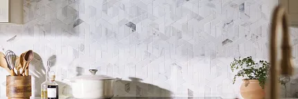 Geometric Patterned Tile Backsplash in Contemporary Kitchen Design Modern kitchen with geometric patterned tile backspash in neutral tones, featuring a sleek black range hood and white cabinetry