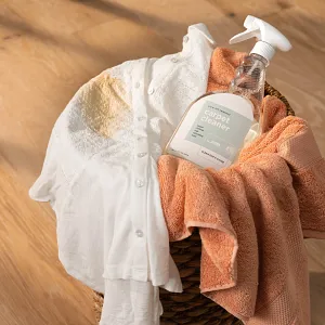 Easy-to-maintain light wood flooring with homely comfort Basket with white and peach towels and carpet cleaner on light wood flooring