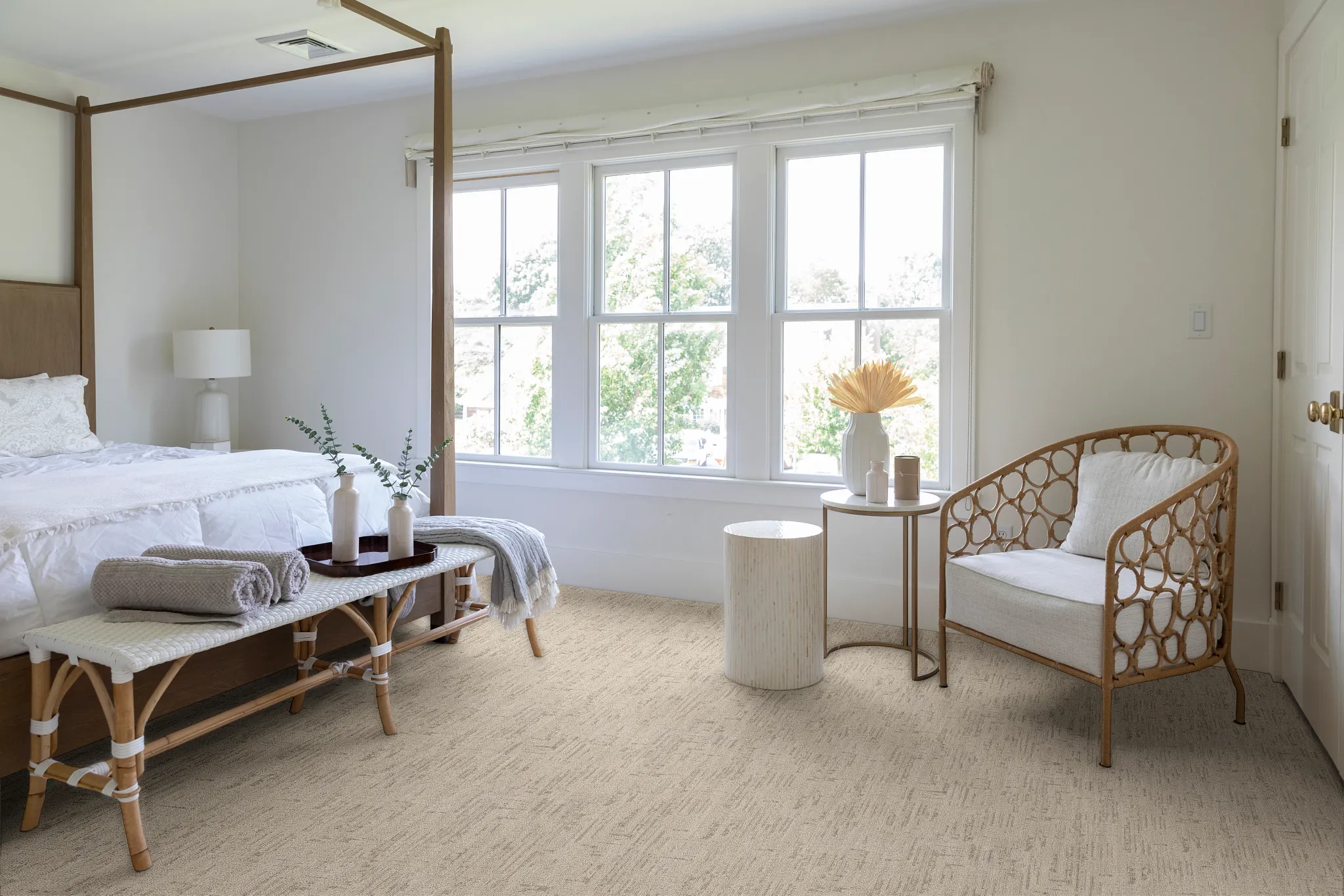 Overhead view of two people selecting flooring samples including carpet, hardwood, and tile on a black table