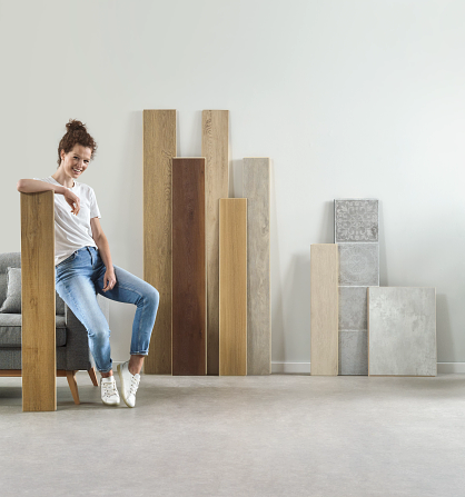 A woman sitting on a couch in a room with luxury vinyl planks.