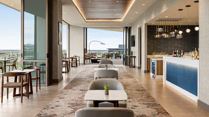 Hospitality Lounge with Stylish Flooring and Bar Area Modern hospitality lounge with elegant seating and a bar area, featuring a mix of tile and carpet flooring.