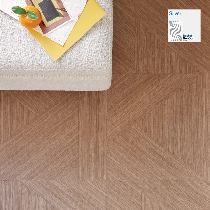 Geometric Brown Flooring with Textured Beige Bench and Books Geometric patterned flooring in a warm brown tone with a textured beige bench and a stack of books with an orange fruit on top