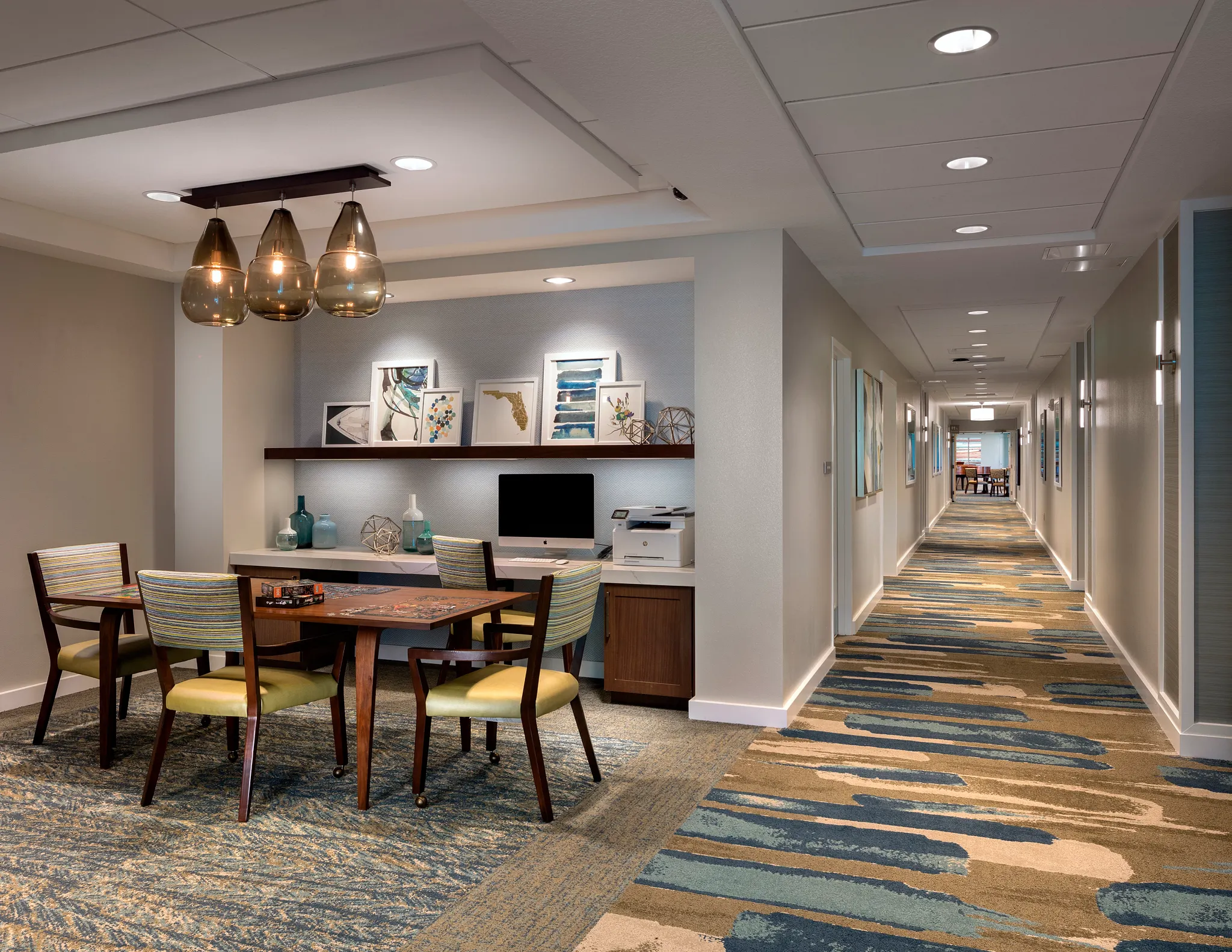 Modern senior living facility with stylish furniture and vibrant commercial carpet tile in shades of blue, beige, and brown