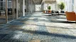 Modern office with geometric patterned carpet in green, blue, and gray