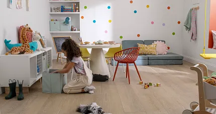 Playroom with Wood Look Luxury Vinyl Plank Flooring Child playing in a colorful playroom with wood look luxury vinyl plank flooring