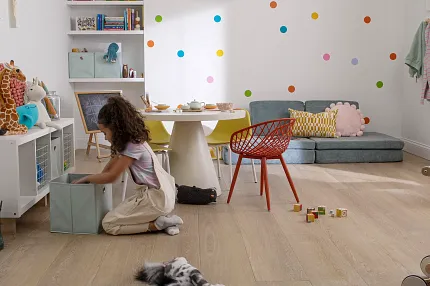 Playroom with Wood Look Luxury Vinyl Plank Flooring Child playing in a colorful playroom with wood look luxury vinyl plank flooring