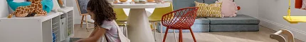 Playroom with Wood Look Luxury Vinyl Plank Flooring Child playing in a colorful playroom with wood look luxury vinyl plank flooring