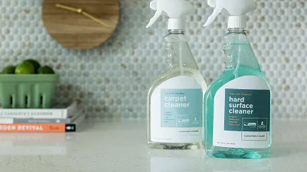 Carpet and Hard Surface Cleaners for Easy Maintenance Two bottles of floor cleaner on a kitchen countertop with a decorative backsplash
