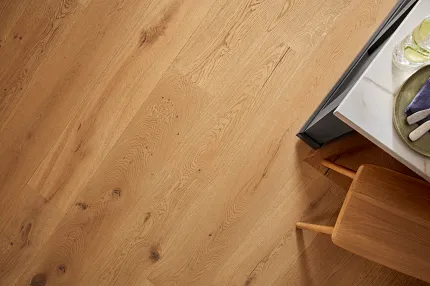 Premium Oak Hardwood Flooring Detail Close-up view of natural oak hardwood flooring with visible wood grain and knots