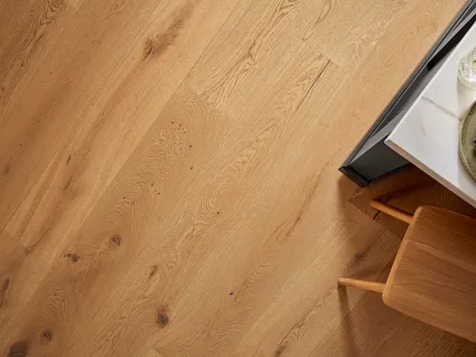 Premium Oak Hardwood Flooring Detail Close-up view of natural oak hardwood flooring with visible wood grain and knots
