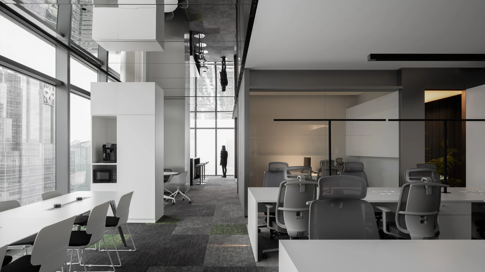 Modern workplace with commercial carpet tile flooring in shades of gray and green, featuring open office layout with ergonomic chairs and large windows