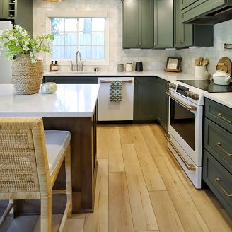A lavish kitchen adorned with green cabinets, complemented by COREtec luxury vinyl floors.