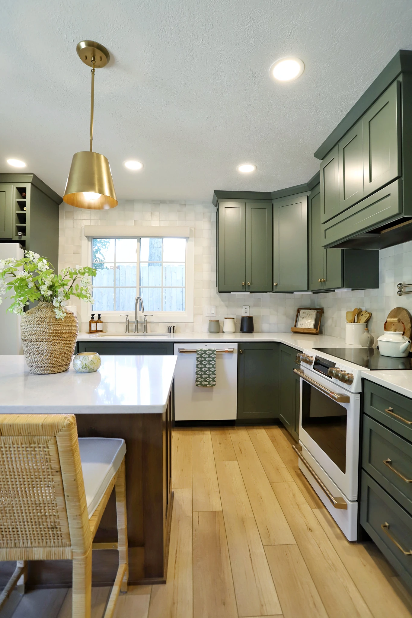 Modern kitchen with green cabinets and luxury vinyl plank flooring