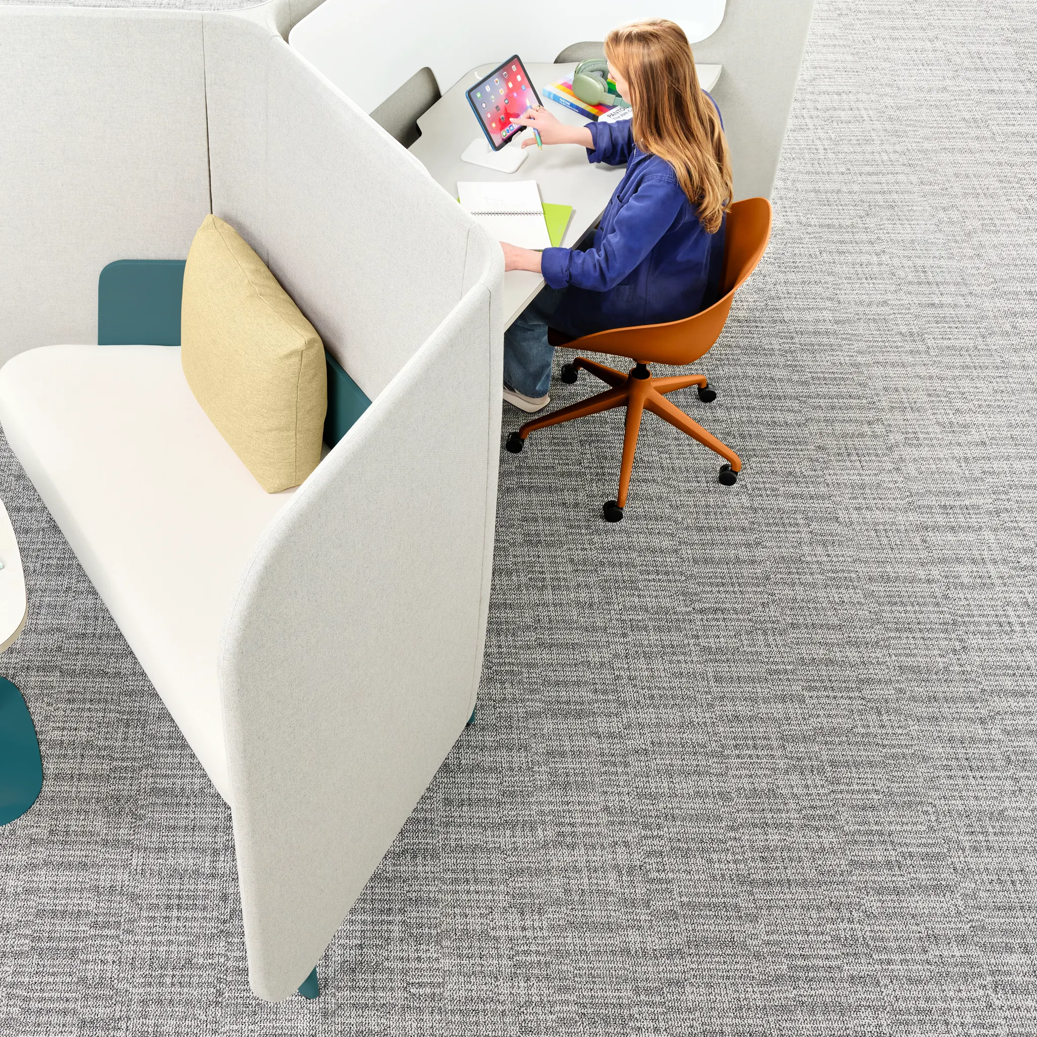 Grey commercial carpet tile in workplace setting with young woman working