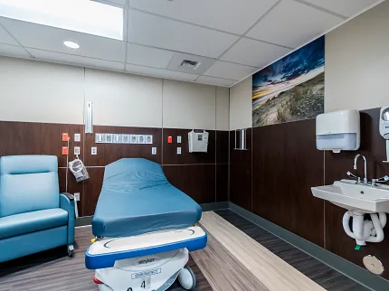 Healthcare Facility Room with Heavy Commercial Luxury Vinyl Tile Flooring Healthcare facility room with heavy commercial luxury vinyl tile flooring in a 36x9 inch dimension, featuring a blue chair and medical bed