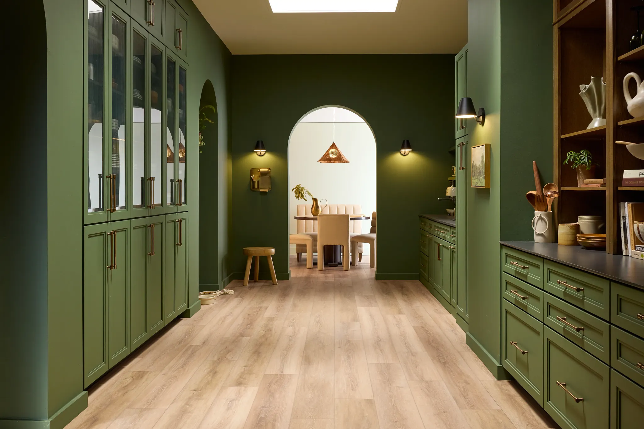 Luxury vinyl plank flooring in a modern kitchen with green cabinetry