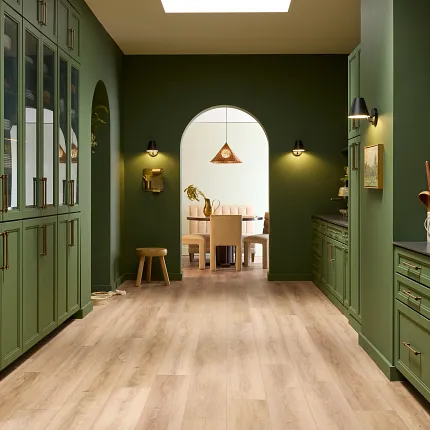 Coretec Residential WPC flooring for stylish interiors Luxury vinyl plank flooring in a modern kitchen with green cabinetry