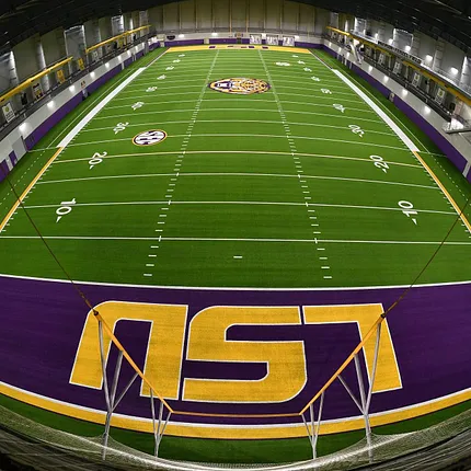 LSU Indoor Sports Facility with Artificial Turf Indoor sports facility with artificial turf featuring LSU logo in purple and gold