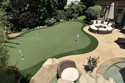 Outdoor putting green with stylish patio design Backyard putting green with patio seating and landscaping