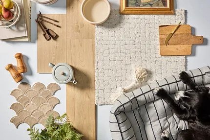 Light Wood Laminate Flooring and Beige Patterned Carpet for Comfortable Living Spaces Cozy home scene with light wood laminate flooring, beige patterned carpet, and a black dog resting on a striped cushion
