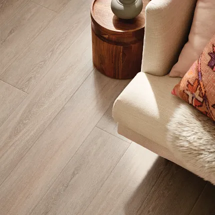 Beige luxury vinyl plank flooring in a cozy living room setting with Coretec Residential WPC construction living room with beige luxury vinyl plank floor with