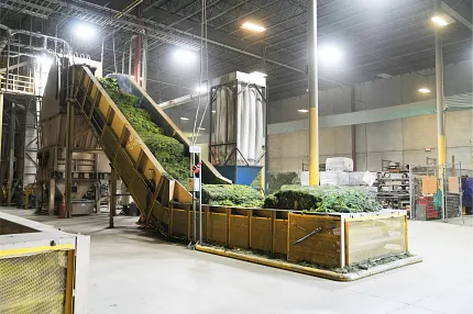 Artificial Turf Manufacturing Process in Factory Artificial turf production facility with conveyor belt and industrial equipment