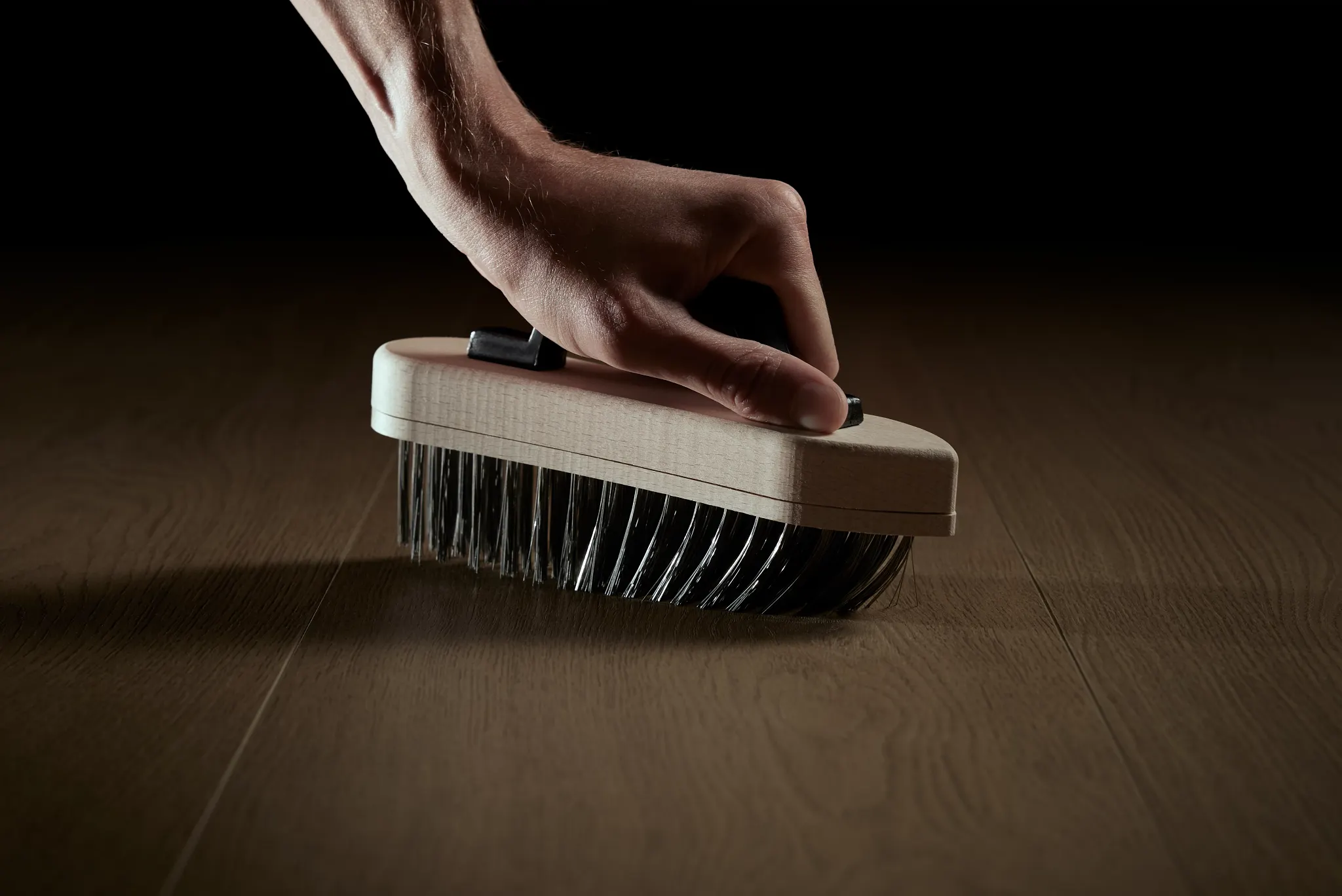 Modern living room with dark wood look luxury vinyl plank flooring and two white armchairs