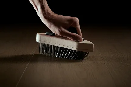 Dark Wood Look Luxury Vinyl Plank Flooring in Modern Living Room Modern living room with dark wood look luxury vinyl plank flooring and two white armchairs