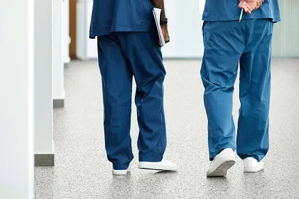Speckled Commercial Flooring in Healthcare Facility Corridor Healthcare professionals walking on speckled commercial flooring in a healthcare facility
