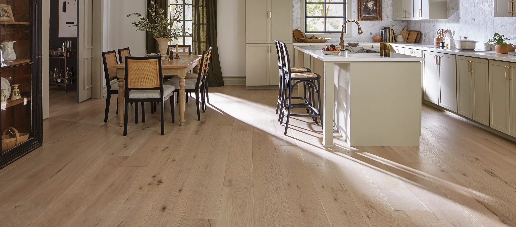 Light wood flooring in a modern kitchen and dining area