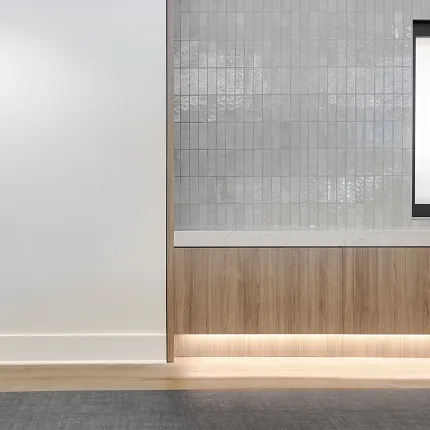 Education Facility with Gray Commercial Carpet Tile and Wood Paneling Modern education facility interior with gray commercial carpet tile and light wood paneling